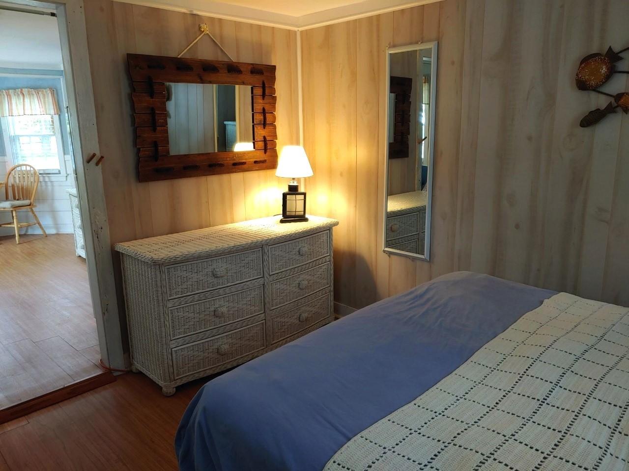 633 Route 6, Unit 3 Wellfleet, MA 02667 - Photo 9 of 9 a bedroom with a bed and a mirror on dresser