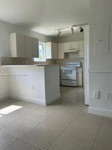 a kitchen with a cabinets and window