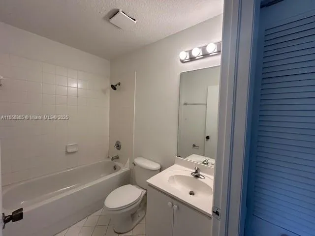 a bathroom with a granite countertop sink a toilet and shower
