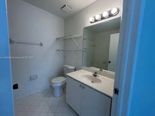 a bathroom with a sink mirror and toilet