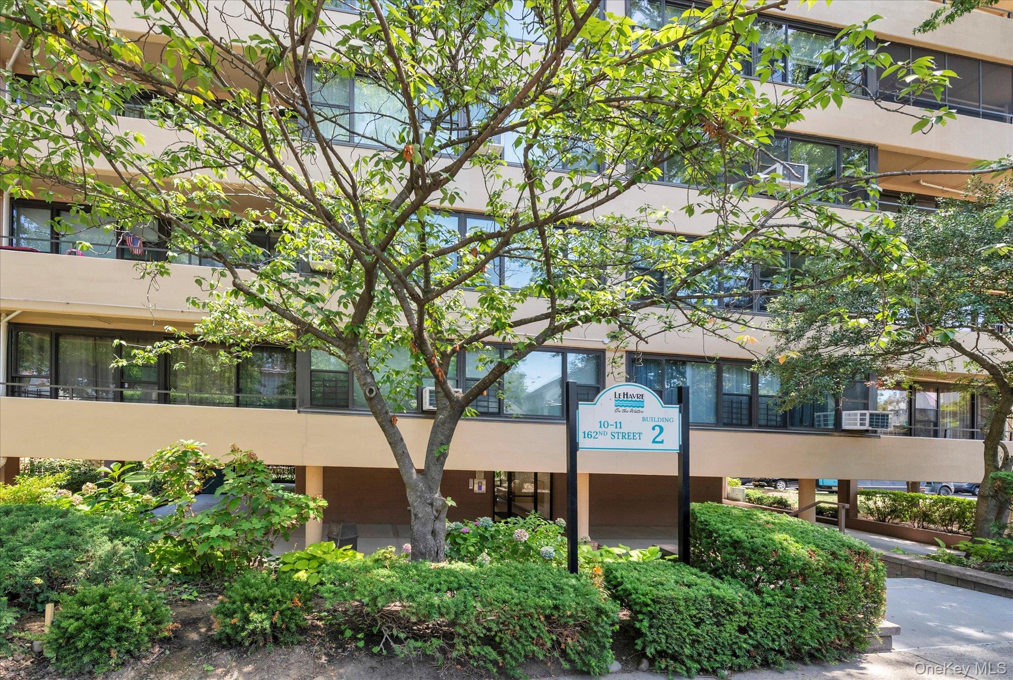 10-11 162nd Street, Unit 7D Queens, NY 11357 - Photo 1 of 1 a front view of a house with garden