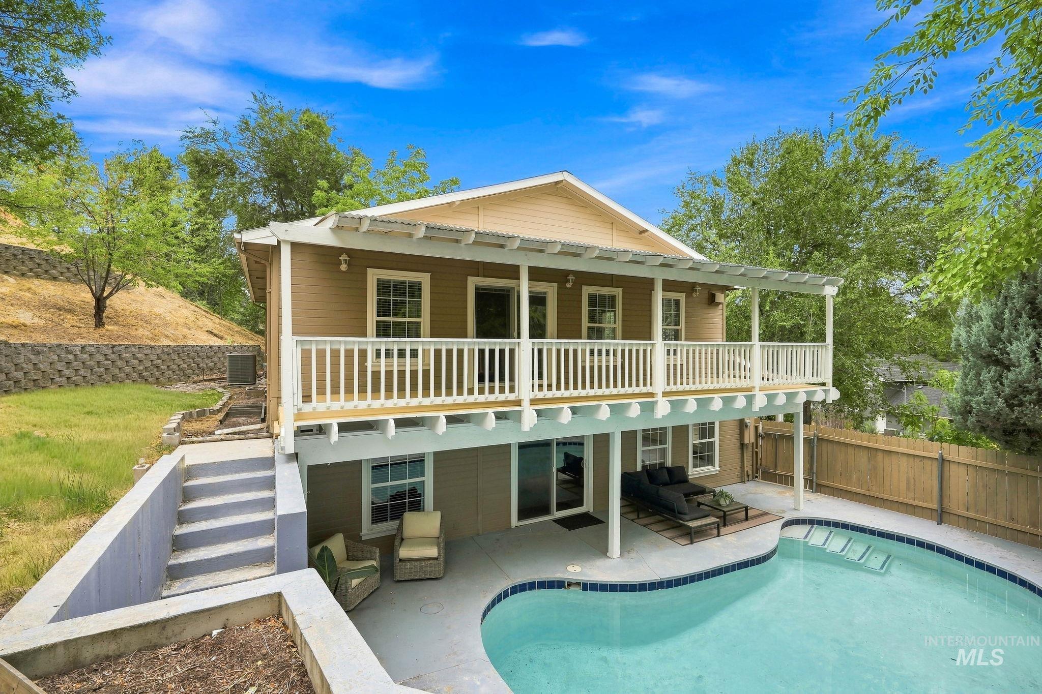 2442 West Hill Road Boise, ID 83702 - Photo 38 of 48 Two-story exterior with a second-level balcony, ground-level patio, and built-in swimming pool