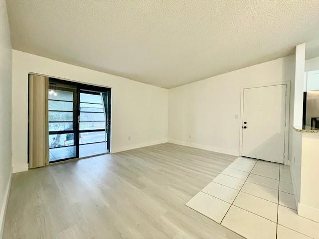 9499 West McNab Road, Unit 208 Tamarac, FL 33321 - Photo 17 of 19 an empty room with wooden floor and white walls