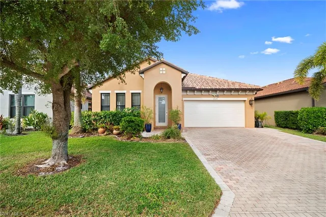a front view of a house with a yard and garage