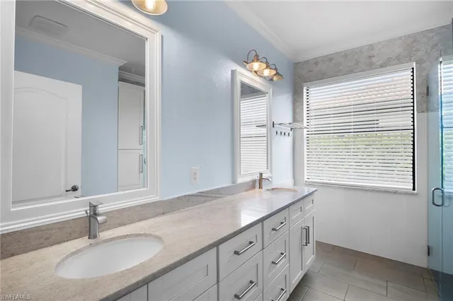a bathroom with a sink double vanity and a mirror