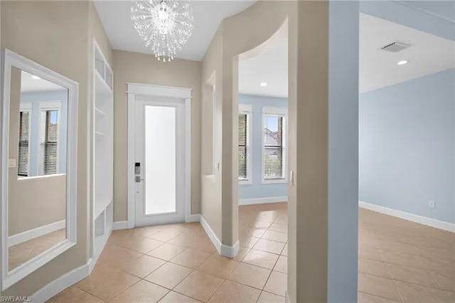 wooden floor with a chandelier