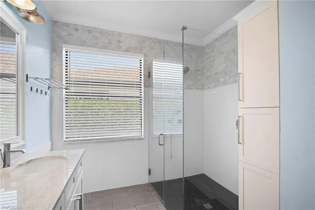 a bathroom with a granite countertop sink and a bathtub