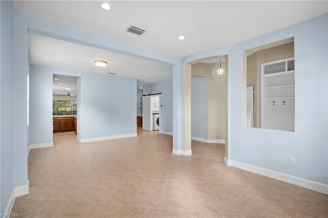 an empty room with a bathroom and a sink