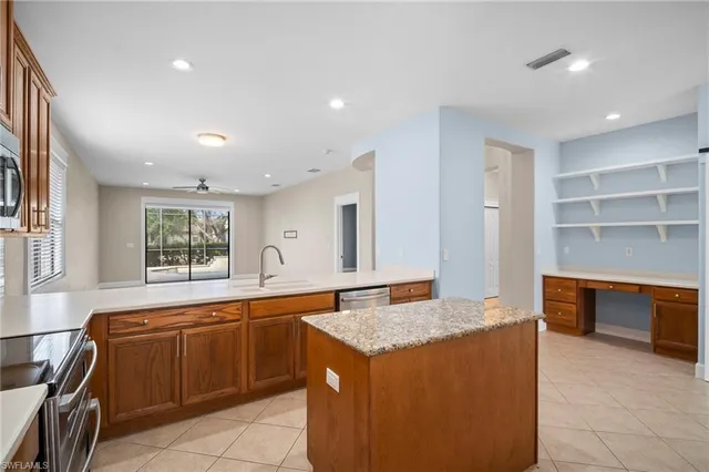 a kitchen with a sink and wooden cabinets