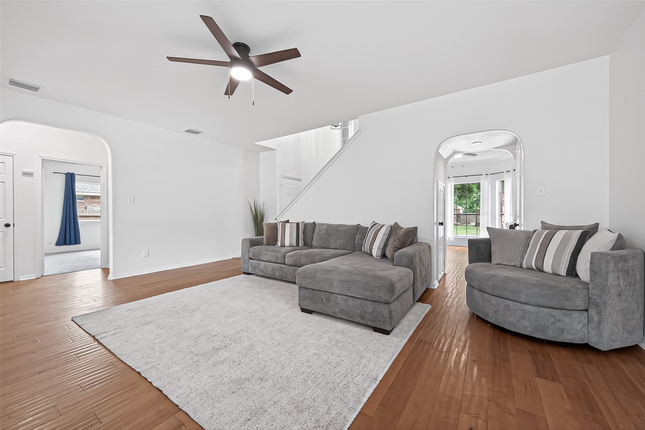 7411 Stonesfield Place Spring, TX 77389 - Photo 7 of 37 1st Floor - Living Room with natural lighting.High efficiency ceiling fans installed for maximum airflow and lower energy consumption.