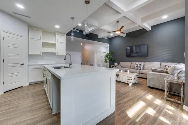 a kitchen with a sink appliances and cabinets