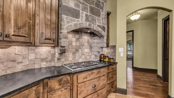 a kitchen with granite countertop cabinets and a stove