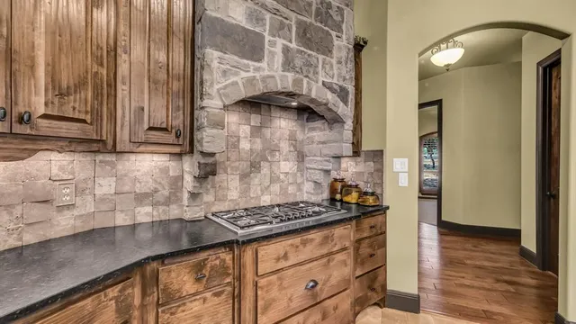 a kitchen with granite countertop cabinets and a stove