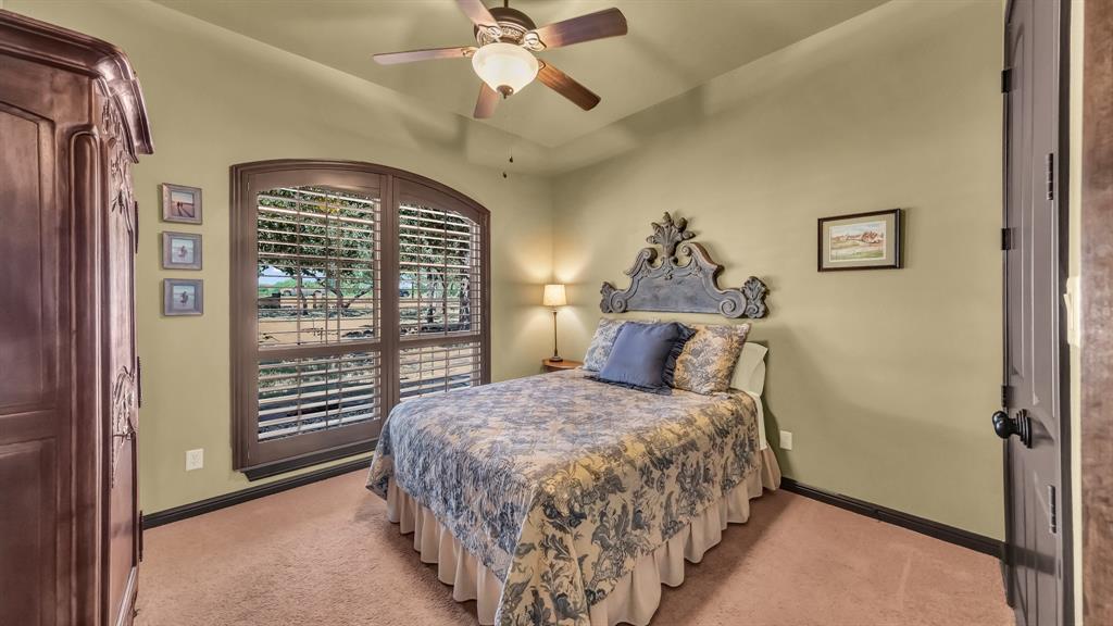 740 Post Oak Road Gordon, TX 76453 - Photo 16 of 40 a bedroom with a bed and a chandelier