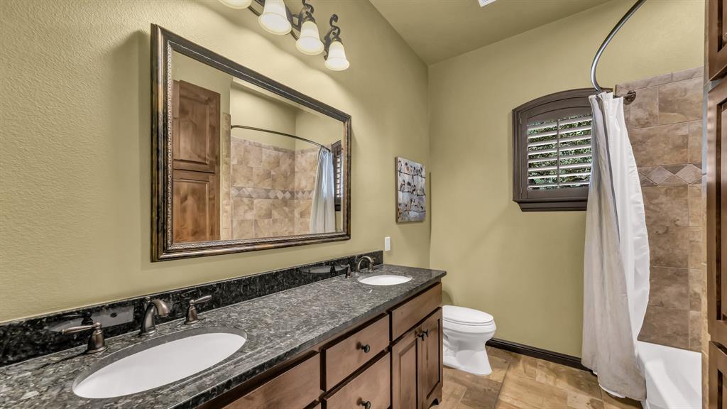 740 Post Oak Road Gordon, TX 76453 - Photo 18 of 40 a bathroom with a granite countertop sink toilet and a mirror
