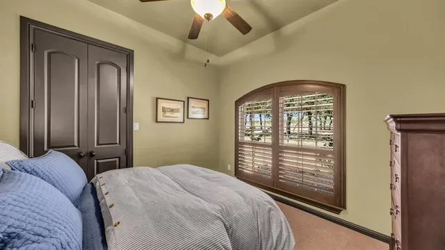 a bathroom with a granite countertop sink toilet and a mirror