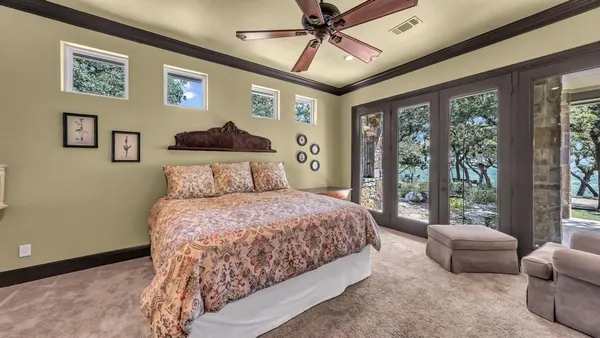 a bedroom with a bed and glass window