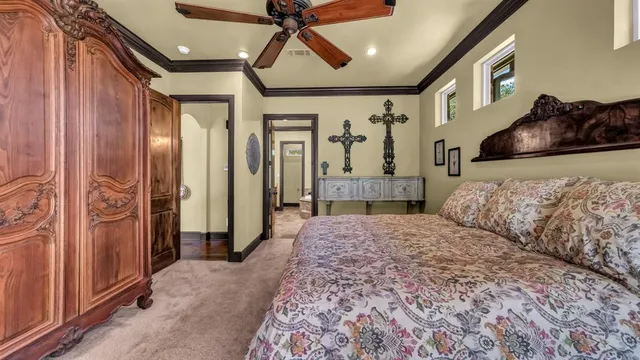 a bedroom with a large bed and a chandelier