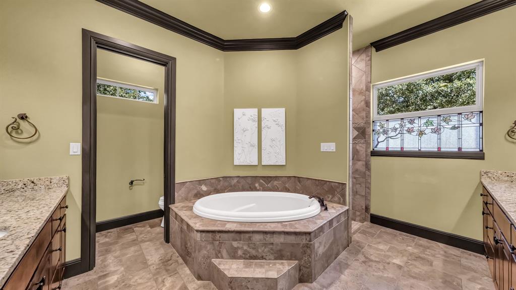 740 Post Oak Road Gordon, TX 76453 - Photo 27 of 40 a bathroom with a granite countertop sink a mirror and a bathtub