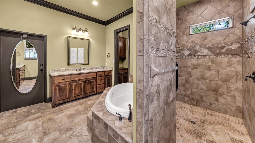 740 Post Oak Road Gordon, TX 76453 - Photo 28 of 40 a bathroom with a sink a mirror and a shower