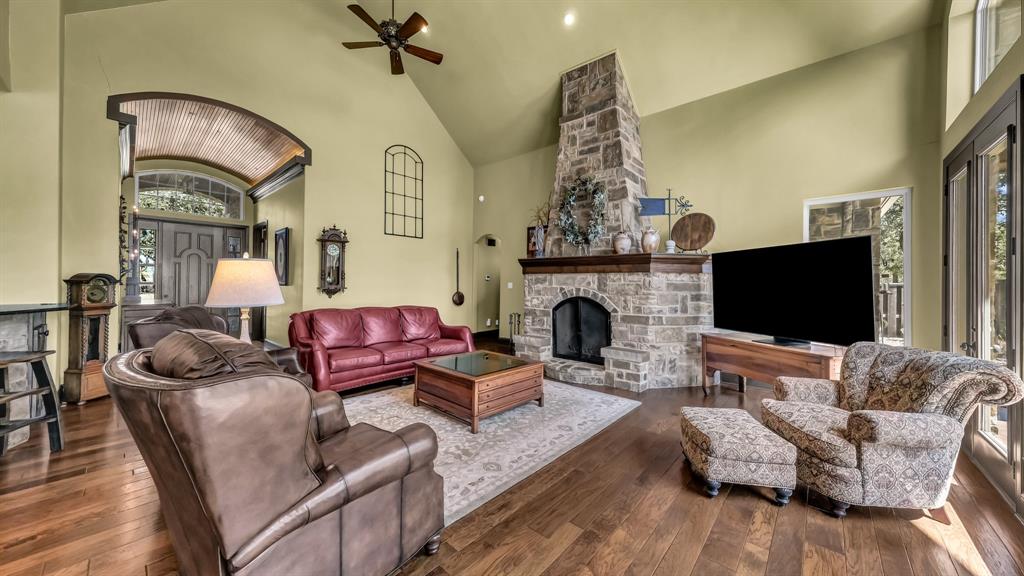 740 Post Oak Road Gordon, TX 76453 - Photo 9 of 40 a living room with furniture a flat screen tv and a fireplace