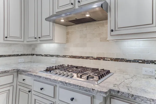 a kitchen with a stove and cabinets