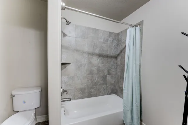 a bathroom with a bathtub and a toilet