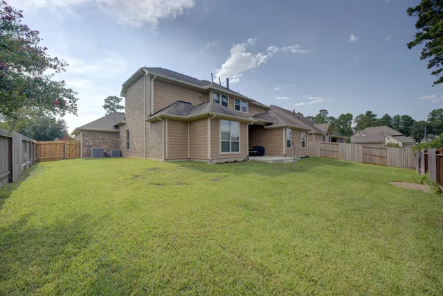 a front view of house with backyard and green space