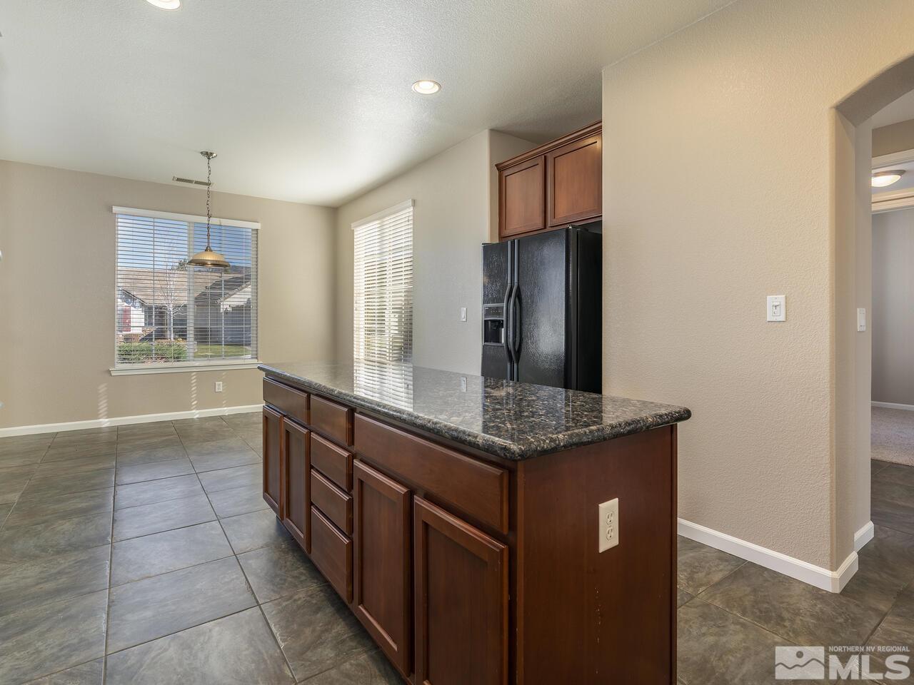 510 Magistrate Court Reno, NV 89521 - Photo 19 of 34 a kitchen with stainless steel appliances granite countertop a sink and a refrigerator