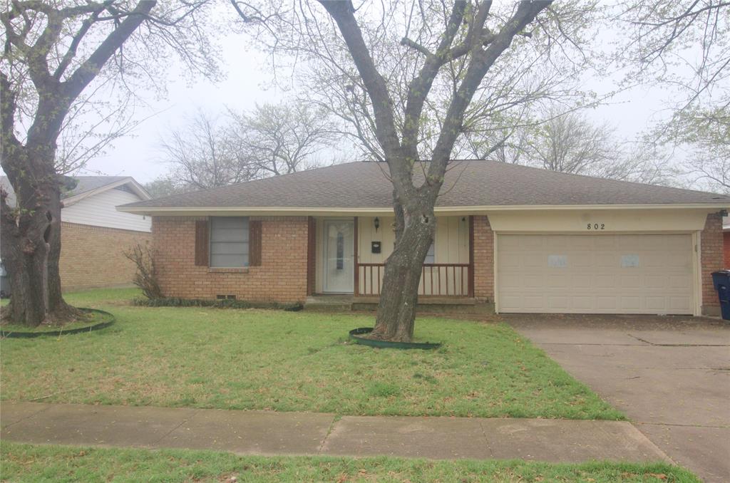 802 Sequoia Drive Lancaster, TX 75146 - Photo 1 of 13 a front view of a house with a yard and garage