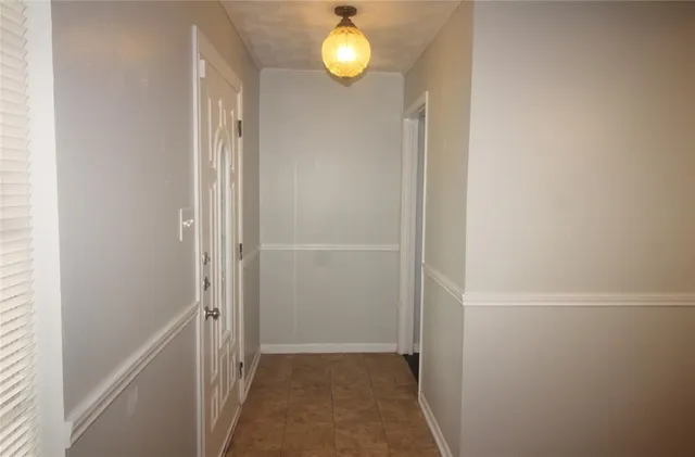 a view of a room with wooden floor and window