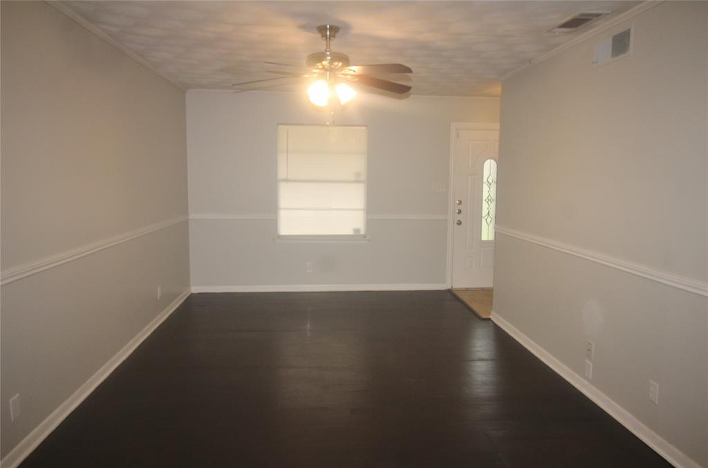 802 Sequoia Drive Lancaster, TX 75146 - Photo 3 of 13 an empty room with wooden floor and windows