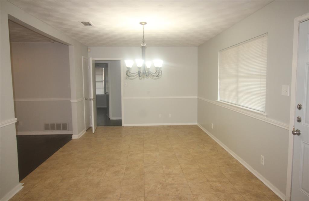 802 Sequoia Drive Lancaster, TX 75146 - Photo 4 of 13 an empty room with chandelier fan and windows