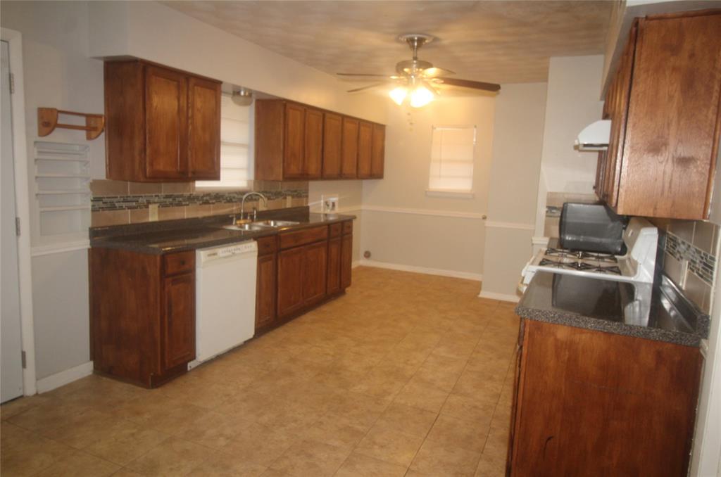 802 Sequoia Drive Lancaster, TX 75146 - Photo 6 of 13 a kitchen with stainless steel appliances granite countertop a stove a sink and a refrigerator