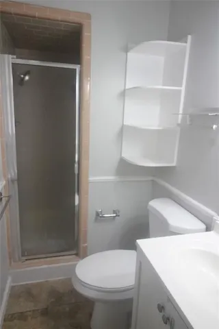 a bathroom with a toilet and a shower