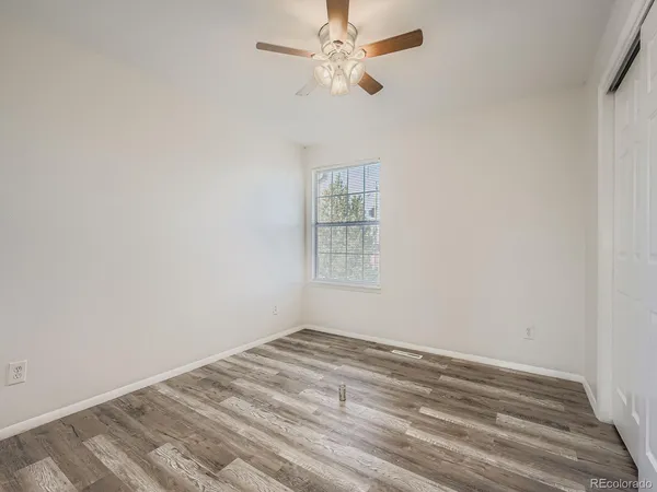 a view of a room with a ceiling fan and a window
