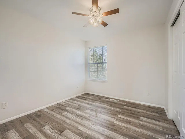 a view of a room with a ceiling fan and a window