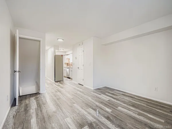a view of empty room with wooden floor