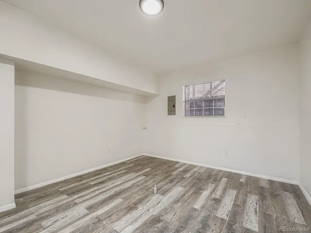 a view of a room with wooden floor and white walls