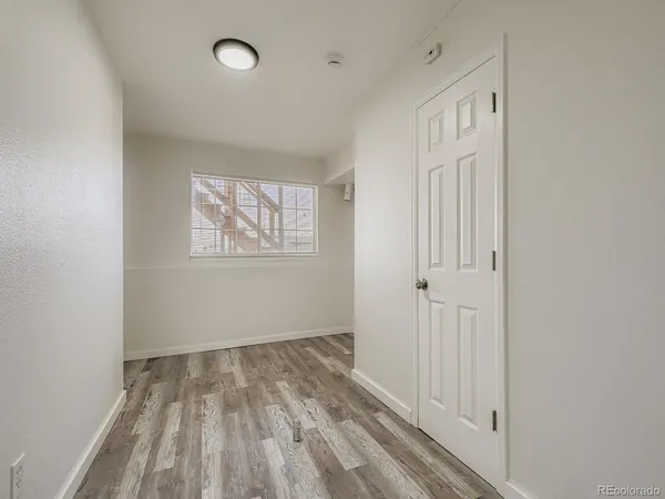 a view of a room with wooden floor and windows