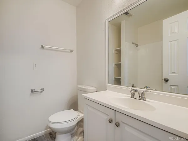 a bathroom with a sink toilet and vanity