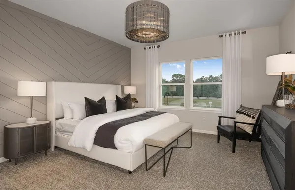 a bedroom with a bed a table and chair