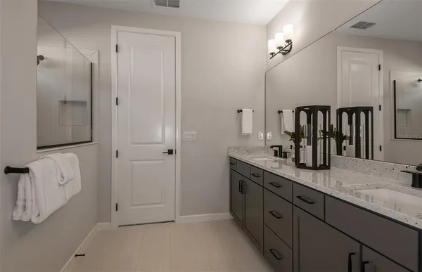 a spacious bathroom with a granite countertop sink and a mirror