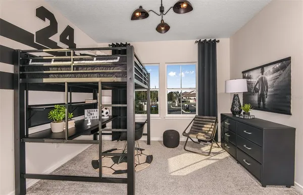 a living room with furniture a flat screen tv and a floor to ceiling window