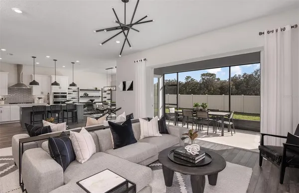 a living room with lots of furniture and a large window