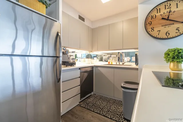 a kitchen with a refrigerator and a sink