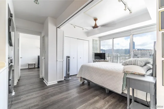 a bedroom with a bed and a large window