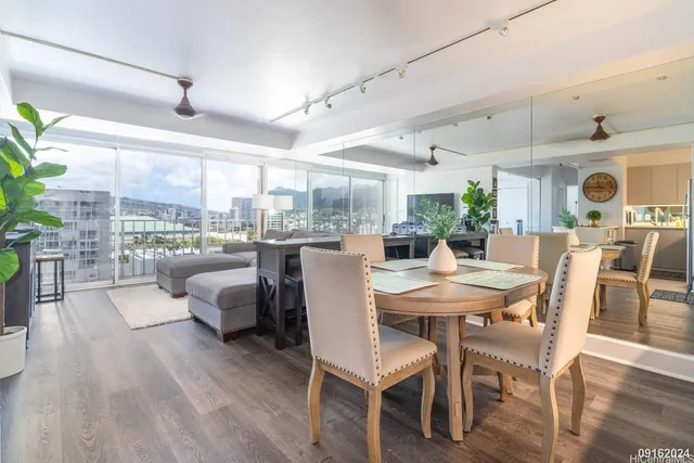 a view of a dining room with furniture window and wooden floor