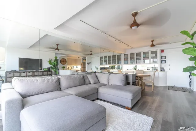 a living room with furniture and a wooden floor