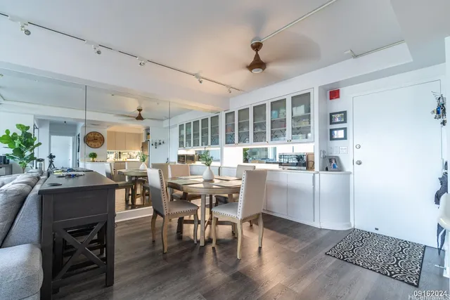 a dining room with furniture window and wooden floor